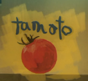 Graffiti featuring a tomato with 'tamoto' written above it in uneven handwriting.