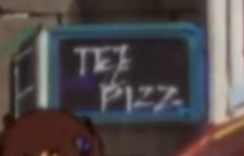 A black sign with a blue border. 'Tez Pizz' is written on it in all caps.